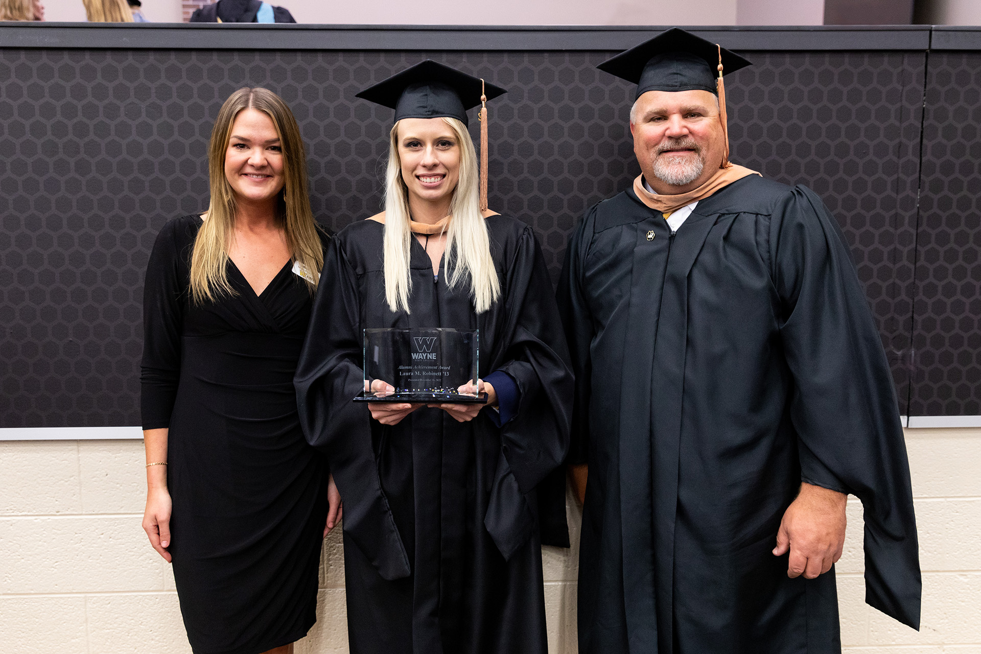Laura Robinett (center), Alumni Achievement Award winner, Winter 2022