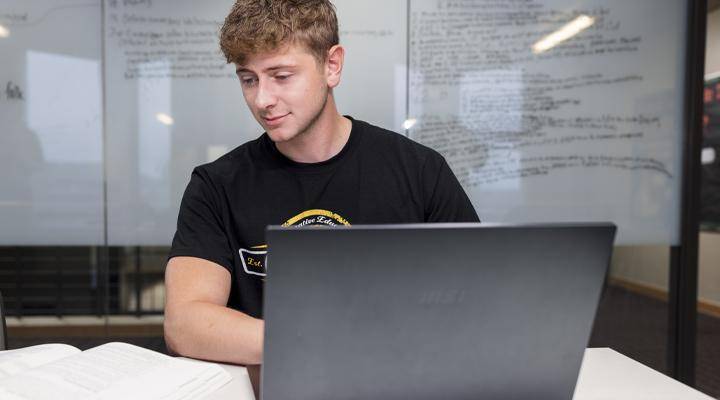 A WSC student at his laptop