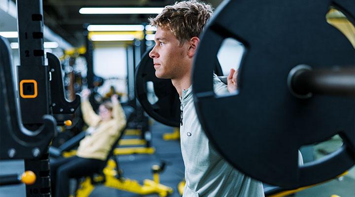 A student lifts weights in the Wellness Center at Wayne State College