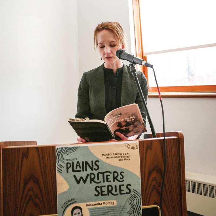 A featured author reads from her selections during the Plains Writer Series