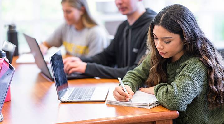 A student works on homework in the library