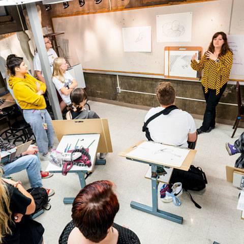 Francine Fox works with art students in the drawing studio.