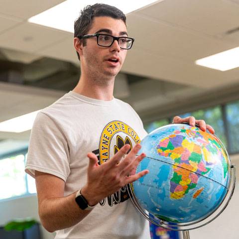 A WSC student practices a geography lecture