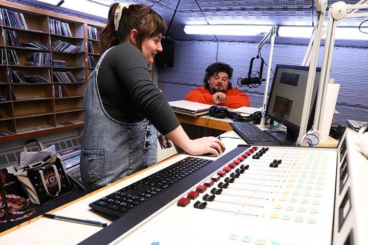 A student broadcasting on-air at the radio station