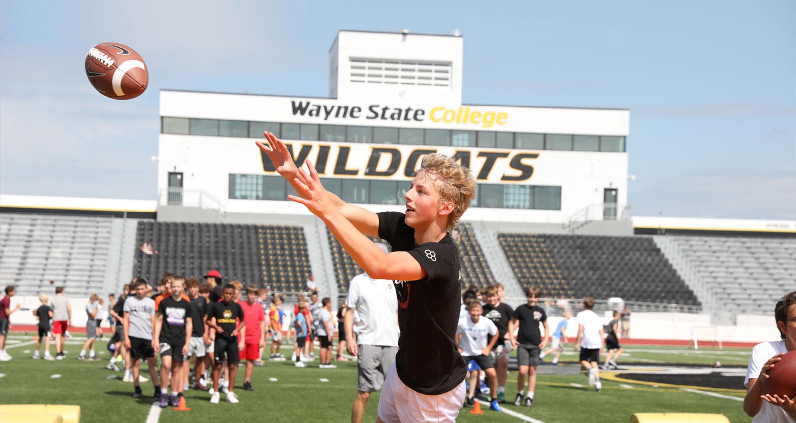 A young man practices receiver drills at a WSC summer football camp