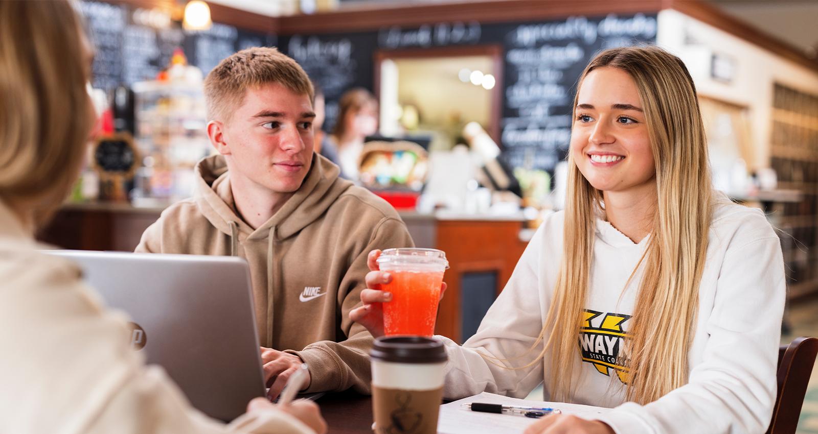 Photo of students socializing at a coffee shop