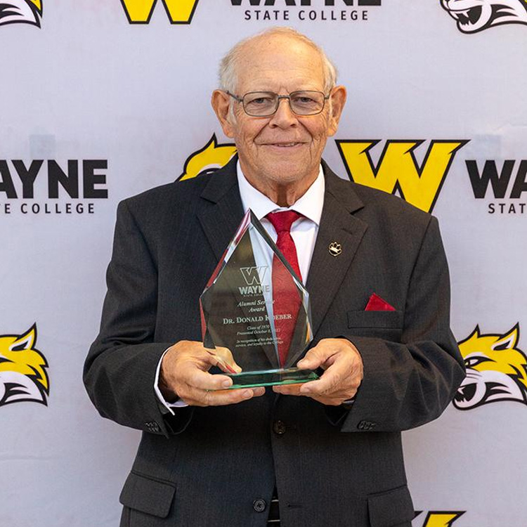 alumni receiving an award from WSC
