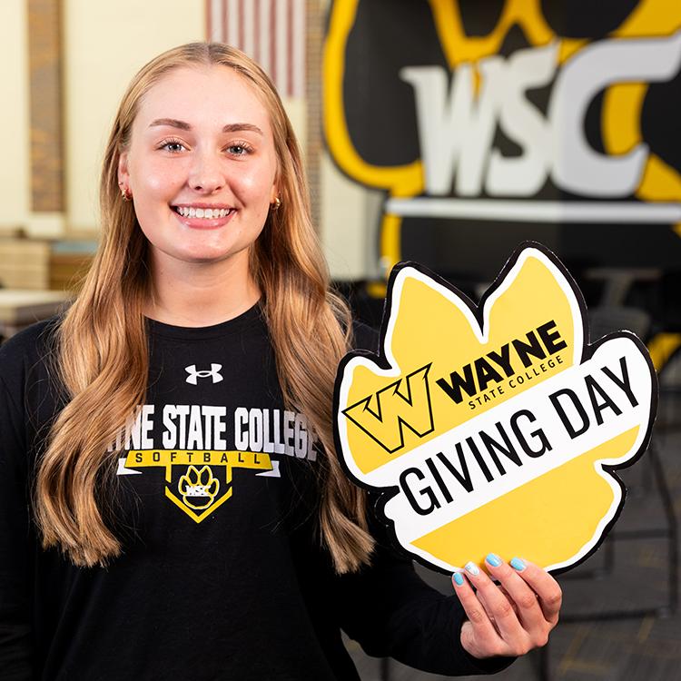A student promotes Giving Day