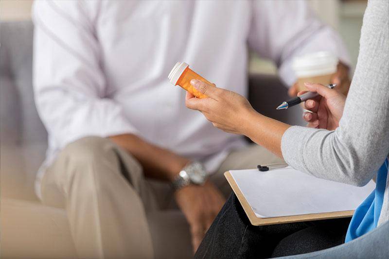A counselor discusses drugs with a client