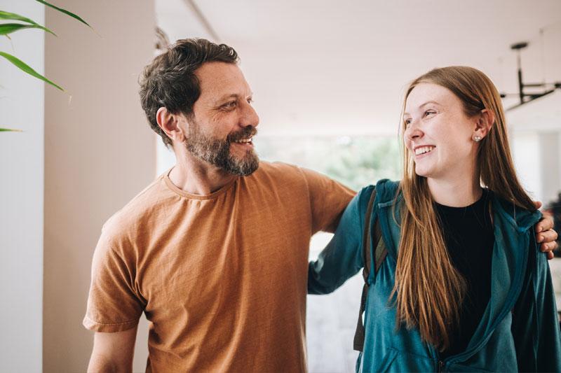 A father and daughter talking while walking