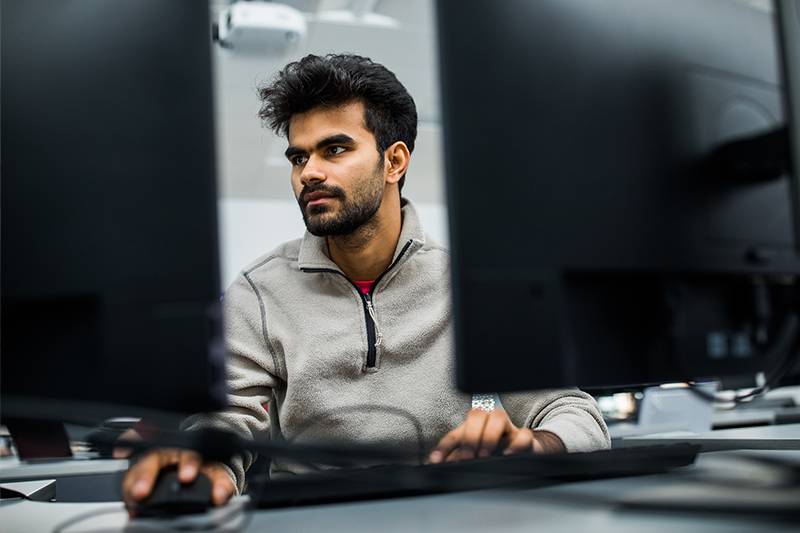 A web specialist degree student works in a computer lab at WSC