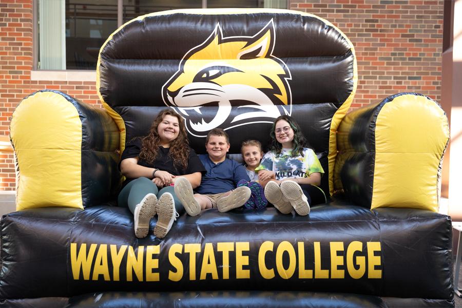 A family sits on WSC's giant inflatable chat in the Student Center