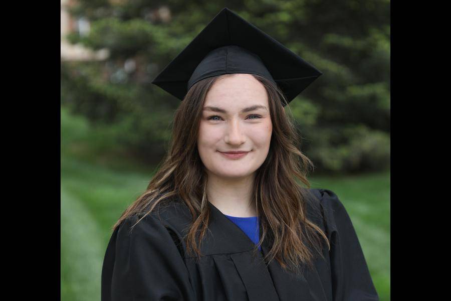 A portrait of Emily Hein in her graduation cap and gown.