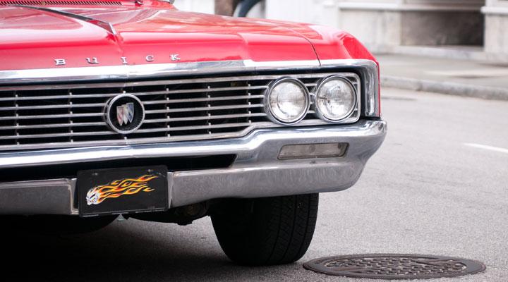 A vintage buick drives downtown