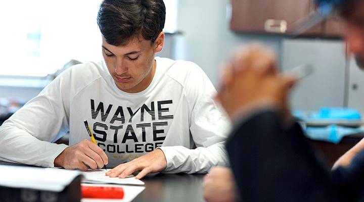 A student takes notes in class