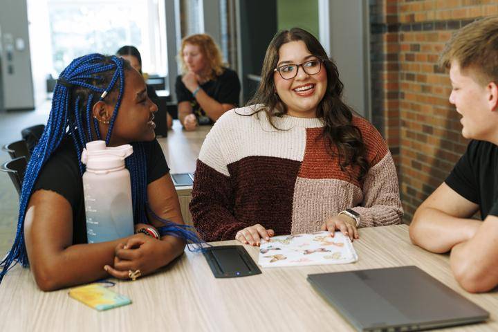 students gather around study table