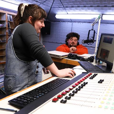 A student broadcasting on-air at the radio station
