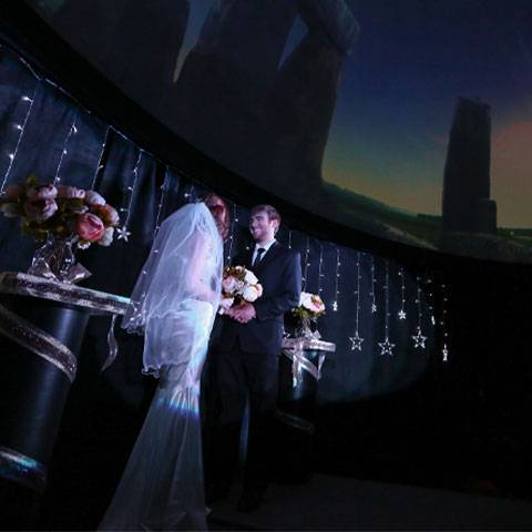 A wedding takes place in the Planetarium at Wayne State College
