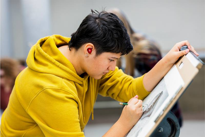 An art student works on a drawing