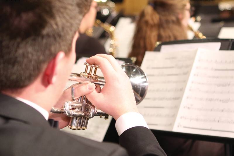A student plays the trumpet in concert