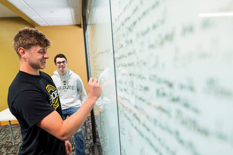 WSC students solve equations on a whiteboard