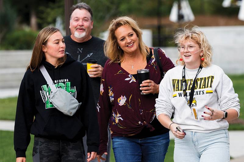 A Navigator leads a family during student visit