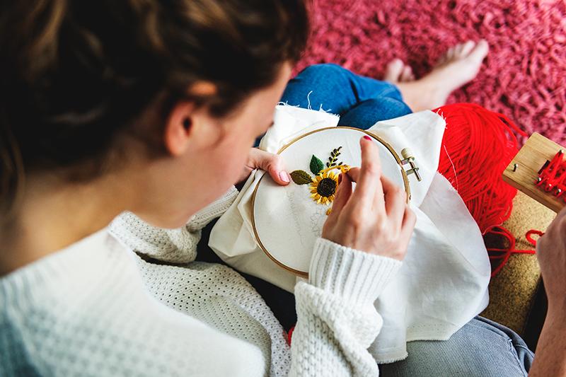 A young woman embroidering