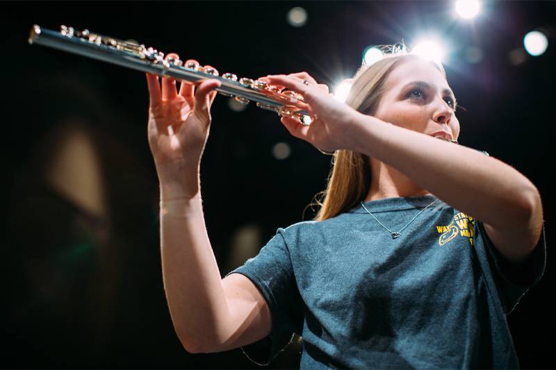 A student plays the clarinet on stage at WSC
