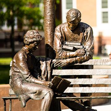 Herb Mignery statue of two students studying on a bench