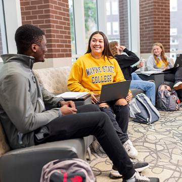 Students work in the library atrium