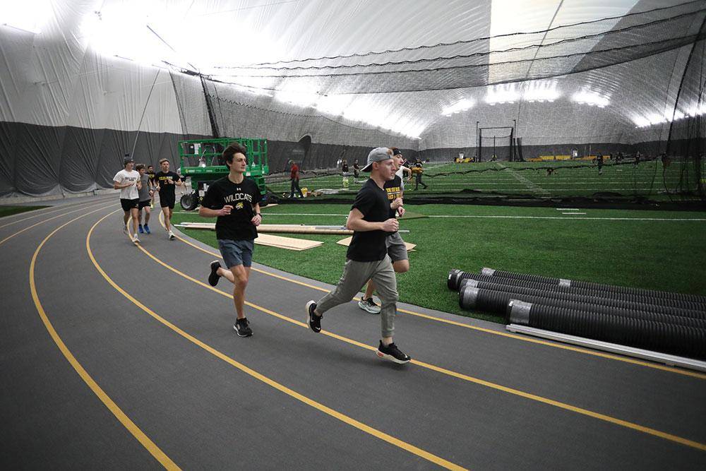 Track athletes run on the Dr. Ron Holt Track