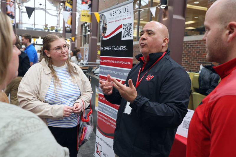 A WSC student meets with a recruiter at the education career fair
