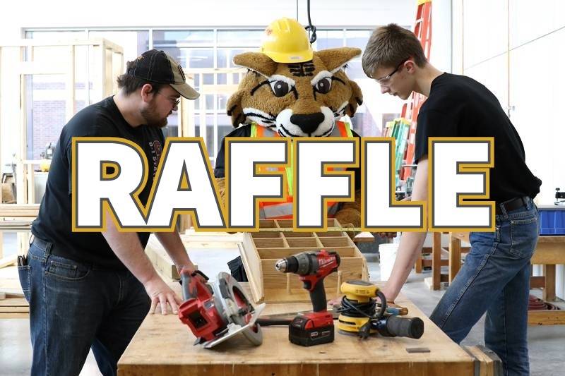 Industrial Tech students standing at a table with tools