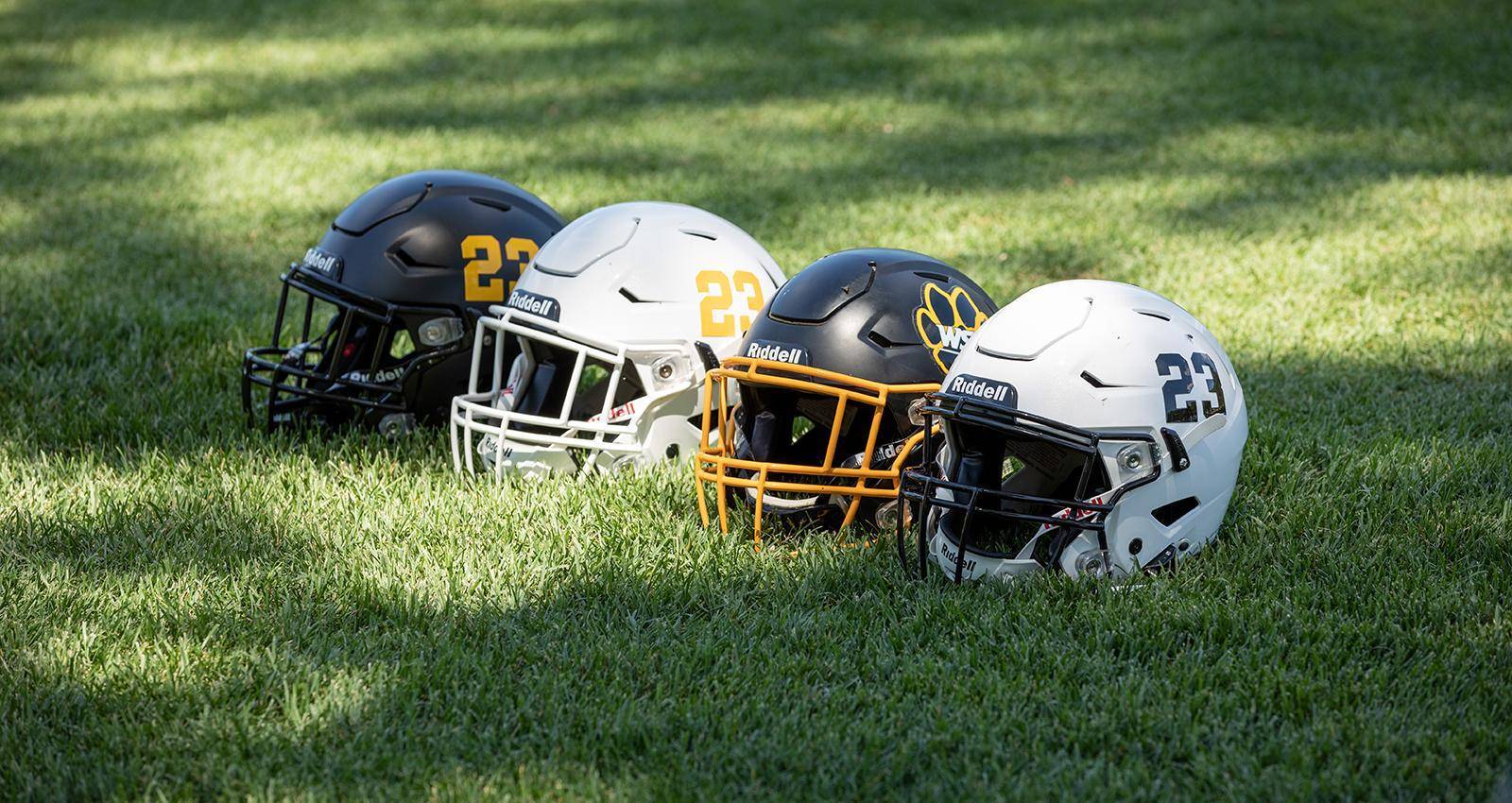 Football helmets on a golf course