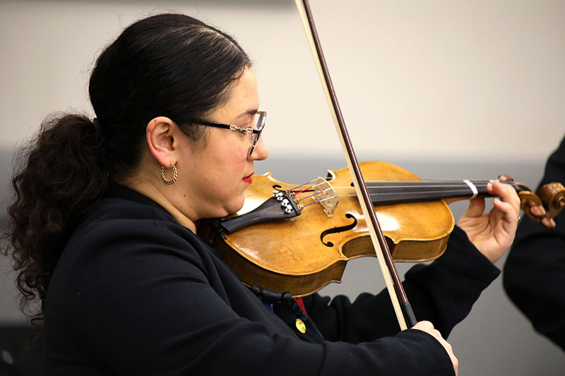 A student plays a violin