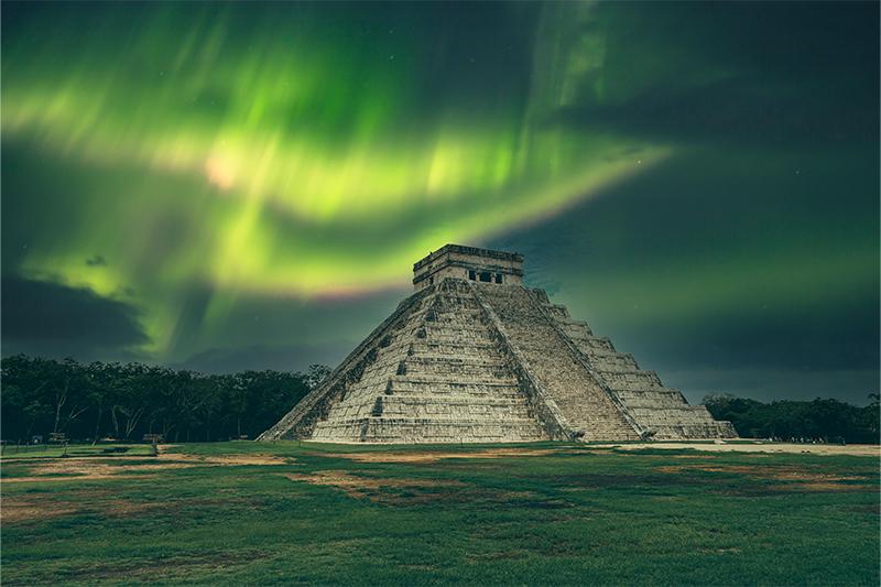 Image of the Northern Lights over a Mayan temple
