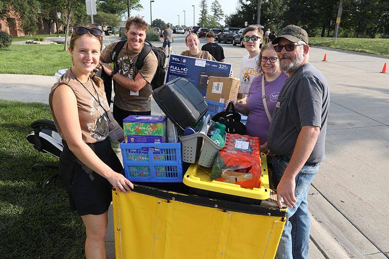 Photo of students and parents moving into residence halls