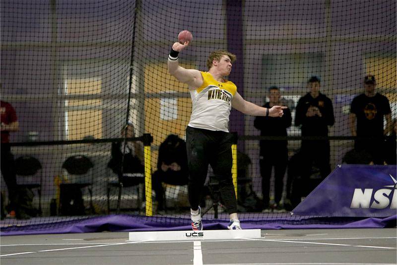 A male throwing a shot put