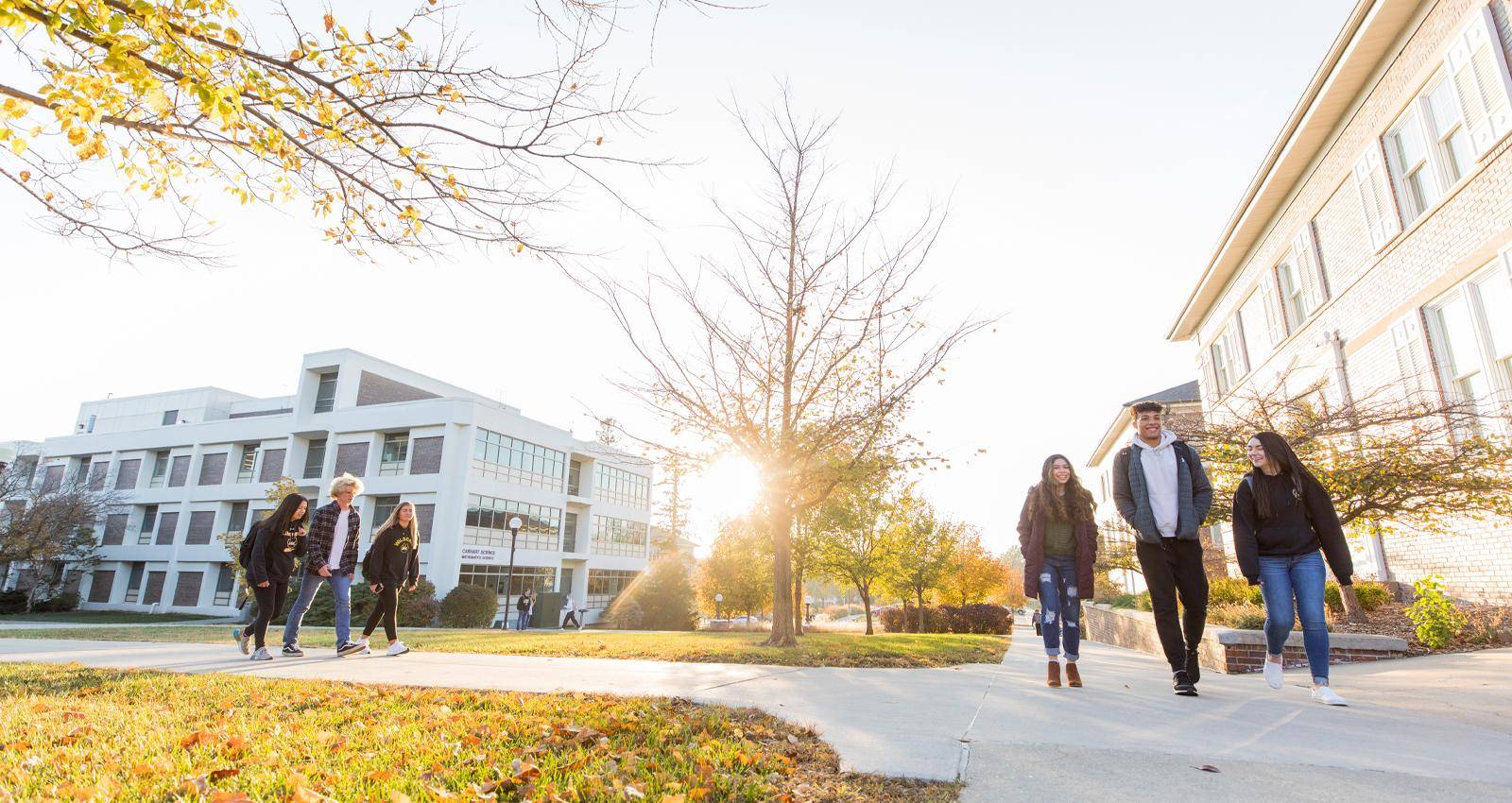 Students walk across campus in the fall