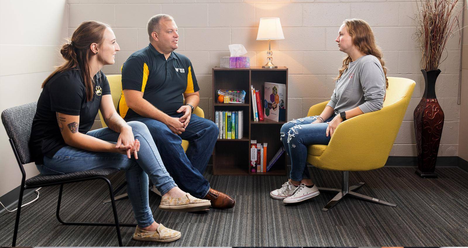 Professors in the Counseling Department work with a student in the Counselor Training Clinic.