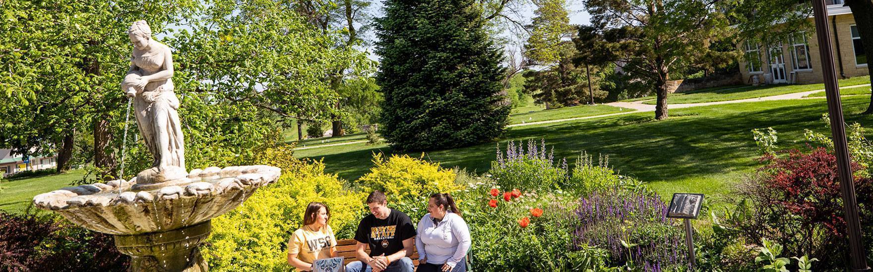A fountain with surrounding landscaping outside of Anderson Hall