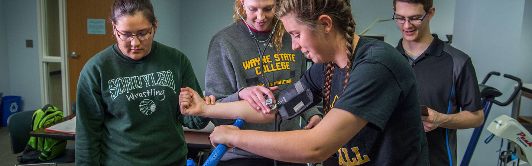 Students measure blood pressure in the Human Performance Lab