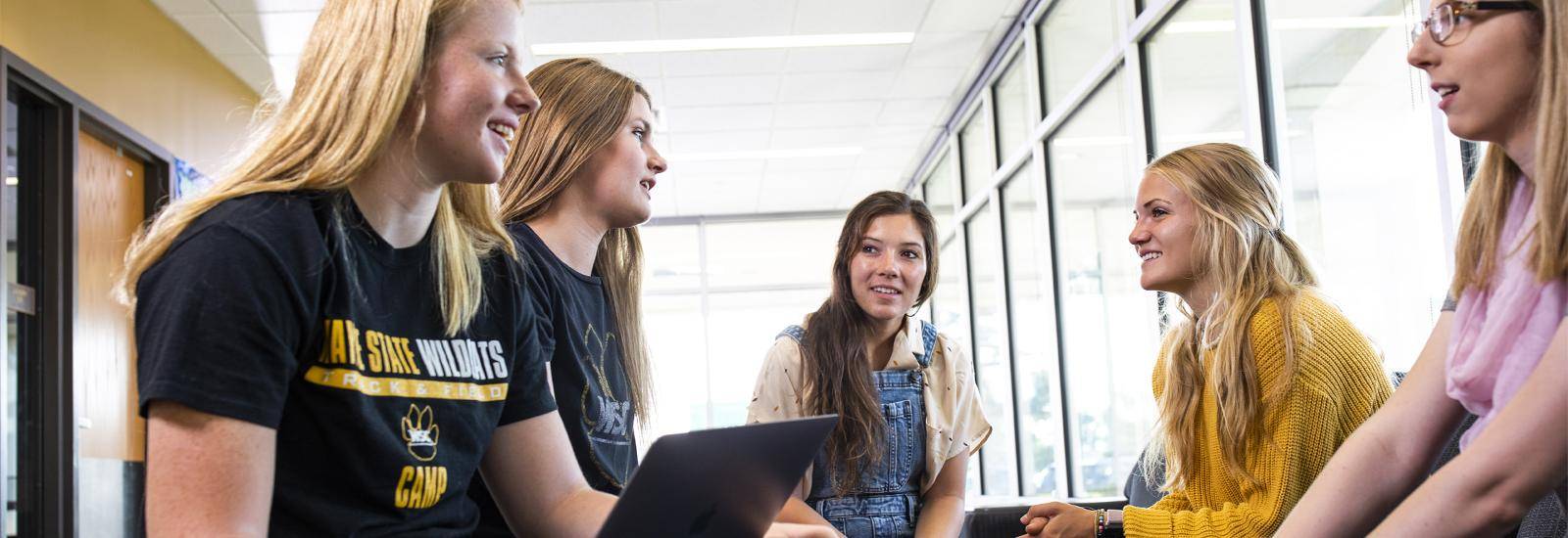 A group of students gather in a residence hall
