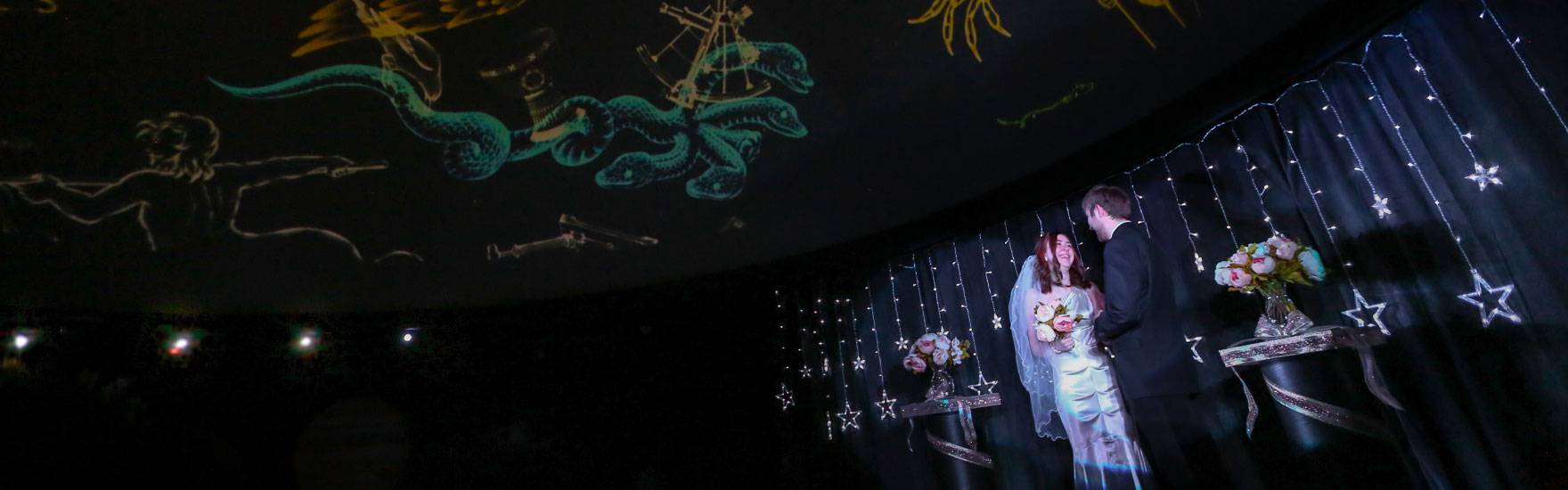 A couple gets married in the Planetarium