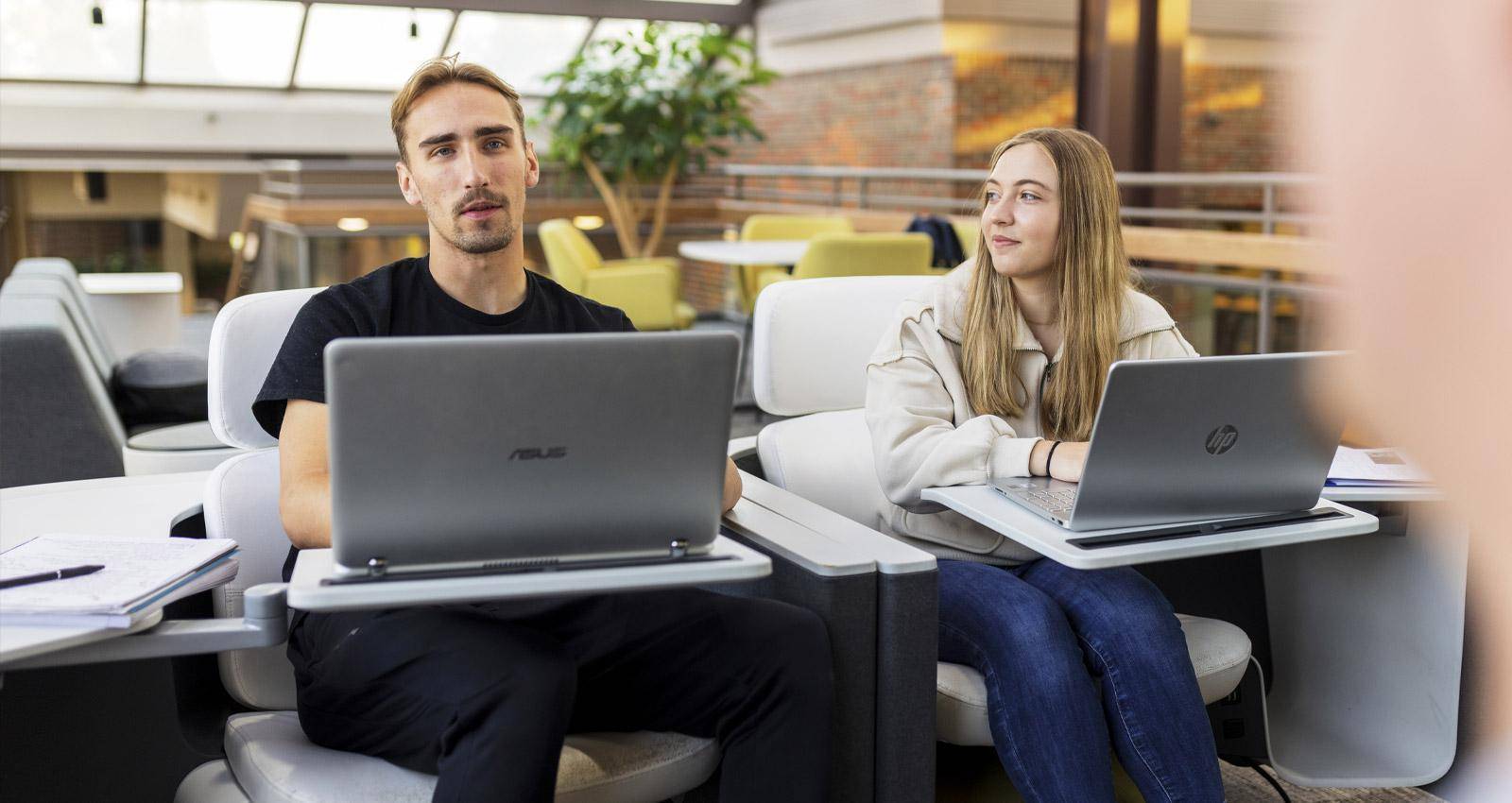 Online graduate programs concept with students on their laptops