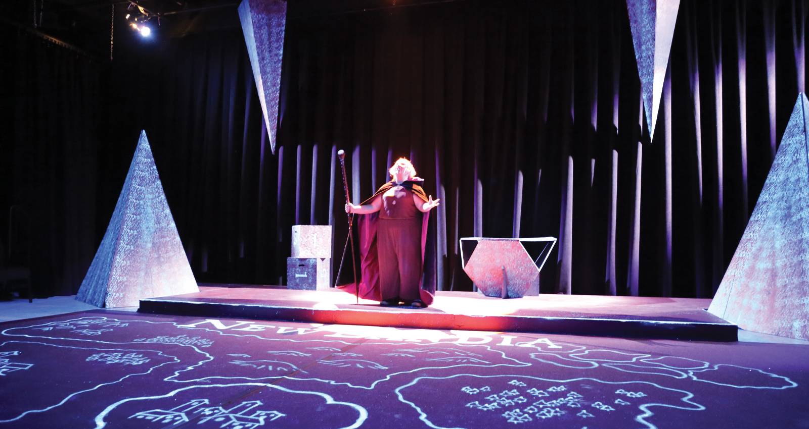 A student monologues on stage during a performance of She Kills Monsters