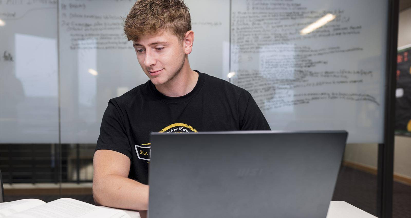 A WSC student on his laptop