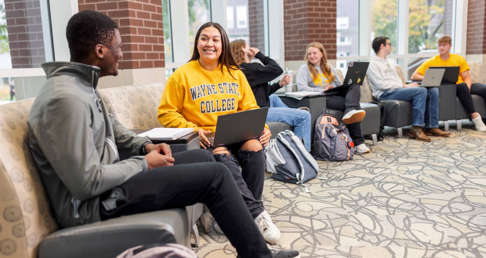 Students socializing in the Conn library