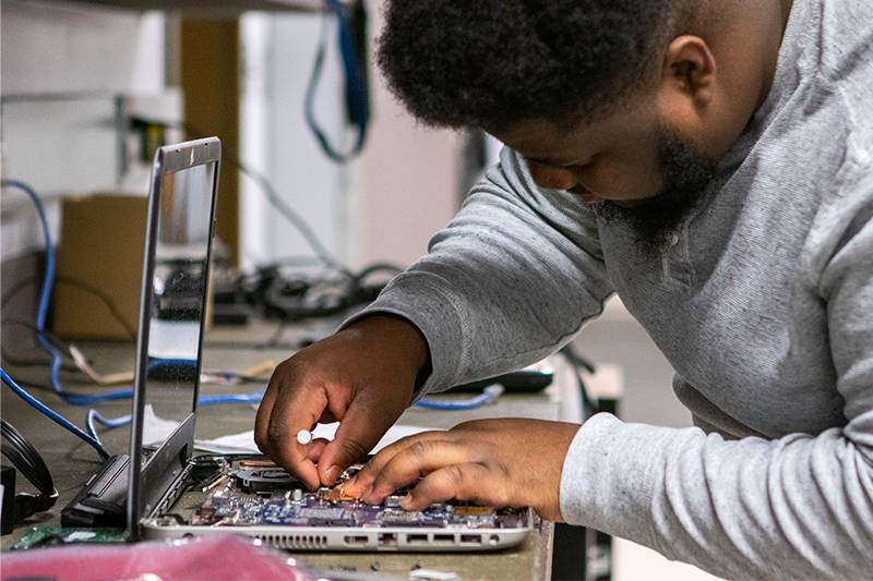 A computer science degree student works in a computer hardware lab at WSC