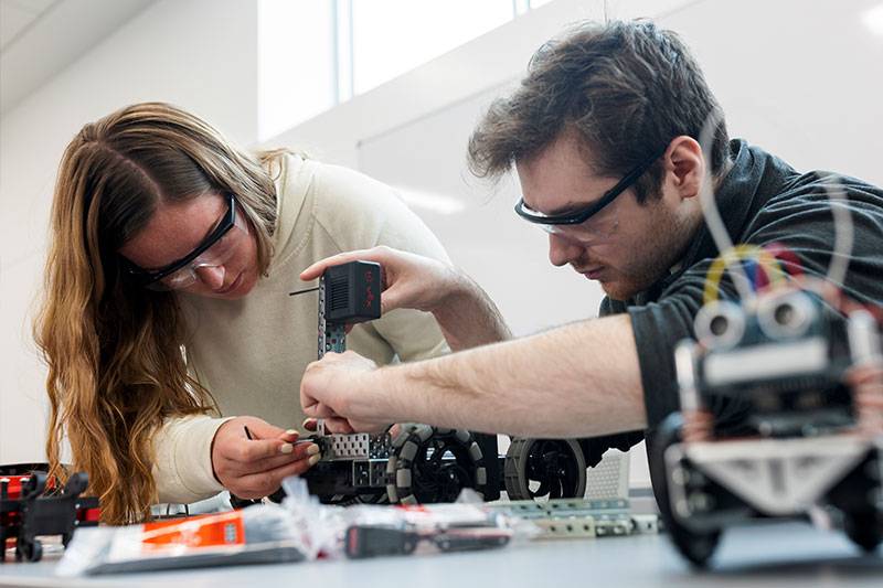 Engineering technology degree students work in a robotics lab at WSC